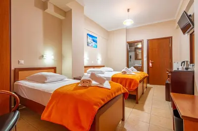 a hotel room with two beds with towels on them at Faros I in Piraeus