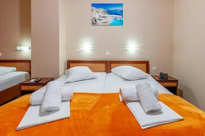 a bedroom with two beds with towels on them at Faros I in Piraeus