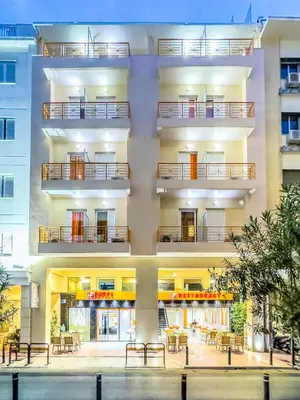 an apartment building with balconies and tables on it at Faros I in Piraeus