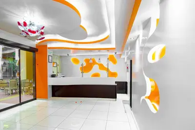 an office lobby with orange and white walls at Faros I in Piraeus