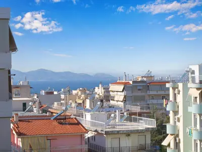a city with buildings and the ocean in the background at Penthouse Apartment & Studio near Glyfada - free Parking in Athens