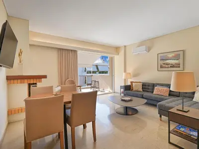 a living room with a table and a dining room at Penthouse Apartment & Studio near Glyfada - free Parking in Athens