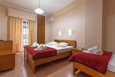 a bedroom with two beds with towels on them at Faros II in Piraeus