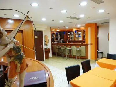 a restaurant with a table and a bar with chairs at Faros II in Piraeus