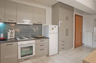 a kitchen with white appliances and a white refrigerator at Ella Suite Piraeus Stylish St, Balcony & Sea View in Piraeus