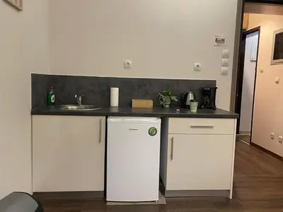 a kitchen with a white refrigerator and a sink at Metropolis A1-Γοητευτική Σουίτα in Athens