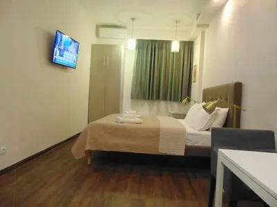 a hotel room with a bed and a tv at Metropolis A1-Γοητευτική Σουίτα in Athens