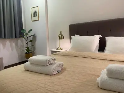 a bedroom with two beds with towels on them at Metropolis A1-Γοητευτική Σουίτα in Athens