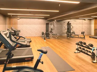 a gym with a treadmill and exercise equipment in it at St George Lycabettus Lifestyle Hotel in Athens