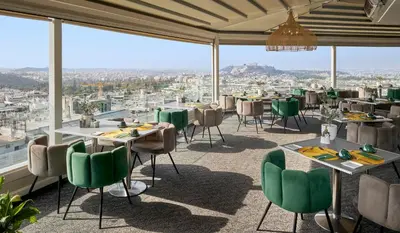 a restaurant with tables and chairs and a view at St George Lycabettus Lifestyle Hotel in Athens