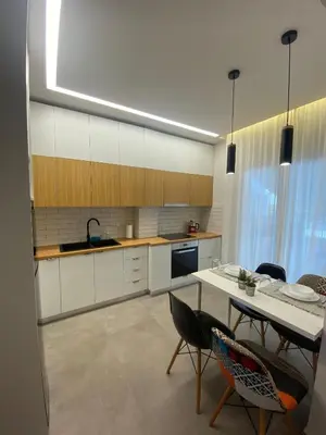 a kitchen with a table and chairs in a room at Piraeus Apartment for rent in Piraeus