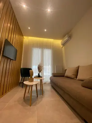 a living room with a couch and a table at Piraeus Apartment for rent in Piraeus