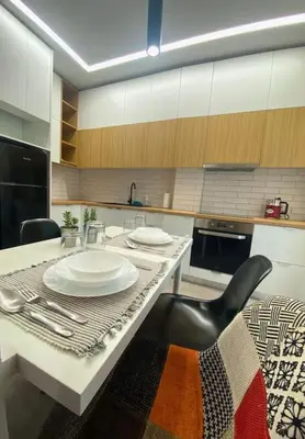 a kitchen with a table with plates and a black chair at Piraeus Apartment for rent in Piraeus