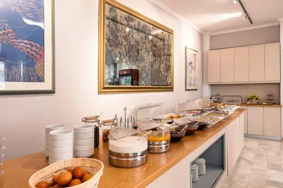 a kitchen with a counter with food on it at Katerina Hotel in Agia Marina Aegina