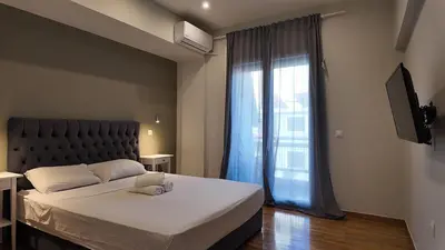 a bedroom with a large bed and a window at Athens City Themis 8 in Athens