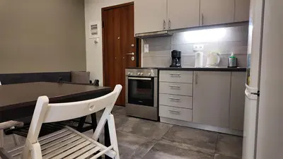 a kitchen with a table and a chair in it at Athens City Themis 8 in Athens