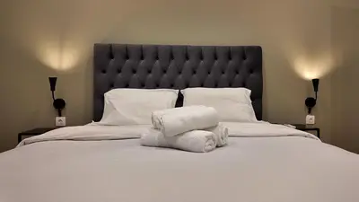 a bedroom with a large bed with towels on it at Athens City Themis 8 in Athens