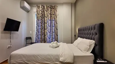 a bedroom with a large bed with a window at Athens City Themis 8 in Athens
