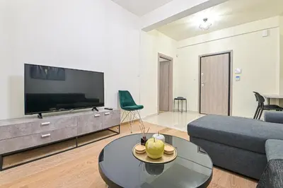 a living room with a couch and a tv at Areos Comfort Living Apartment - Alexandras Ave 72 in Athens