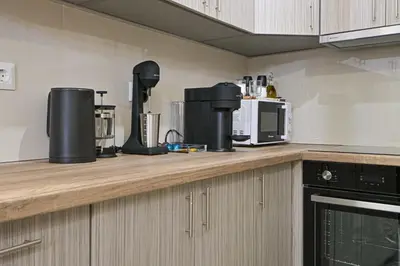 a kitchen with a counter top with appliances on it at Areos Comfort Living Apartment - Alexandras Ave 72 in Athens