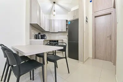 a kitchen with a table and chairs and a refrigerator at Areos Comfort Living Apartment - Alexandras Ave 72 in Athens