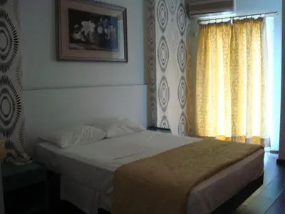 a bedroom with a bed and a window at Minoa Athens Hotel in Athens