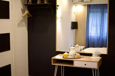 a bedroom with a mirror and a table with food on it at Minoa Athens Hotel in Athens