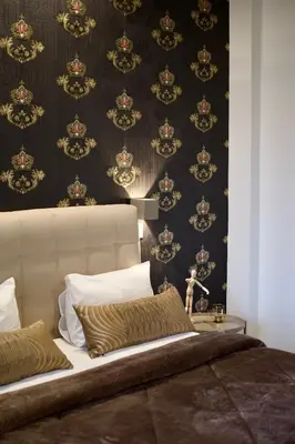 a bedroom with a bed and a black and gold wallpaper at Minoa Athens Hotel in Athens
