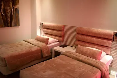 a hotel room with two beds and a couch at Minoa Athens Hotel in Athens