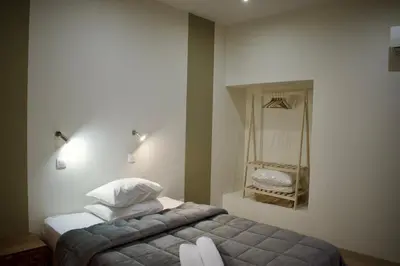 a bedroom with a bed and a mirror on the wall at Nafsika Hotel Athens Centre in Athens