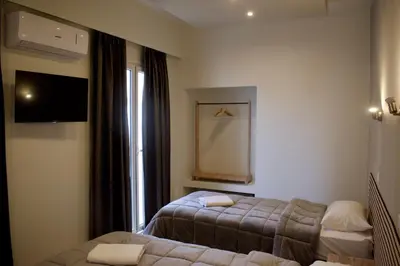 a hotel room with two beds and a tv at Nafsika Hotel Athens Centre in Athens