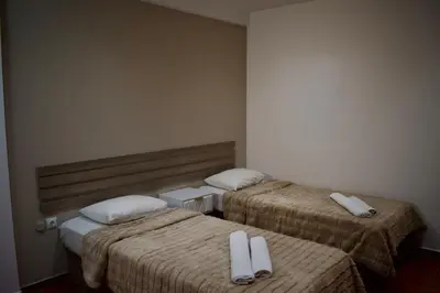 two beds with white pillows in a room at Nafsika Hotel Athens Centre in Athens