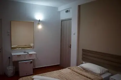 a bedroom with a bed and a mirror and a sink at Nafsika Hotel Athens Centre in Athens