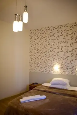 a bedroom with a bed with two towels on it at Nafsika Hotel Athens Centre in Athens