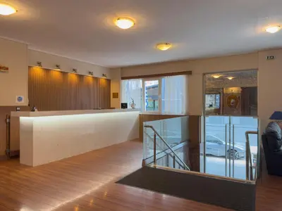 a lobby with a reception desk in a building at Anemoni Piraeus Hotel in Piraeus