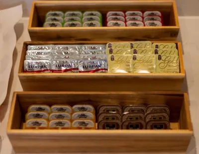 a set of three wooden boxes filled with sushi at Anemoni Piraeus Hotel in Piraeus
