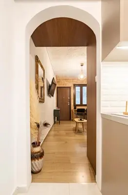 a hallway with an archway in a house at Cute tiny apartment in the heart of Flisvos in Athens