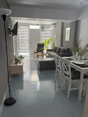 a living room with a couch and a table at Sea Urban 4 Varkiza in Vari