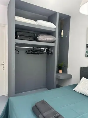 a bedroom with a bed with a blue bed sidx sidx sidx at Sea Urban 4 Varkiza in Vari