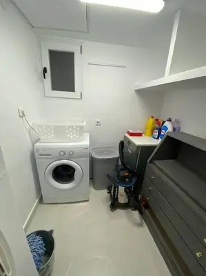 a laundry room with a washing machine and a sink at Sea Urban 4 Varkiza in Vari