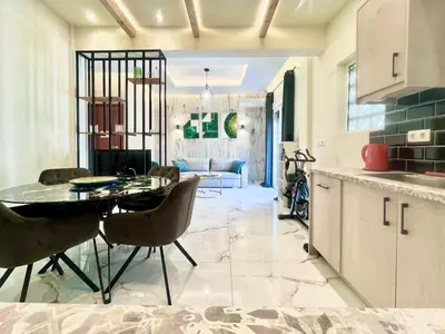 a kitchen and living room with a table and chairs at Stylish Apartment in Athens, Walk Everywhere in Athens