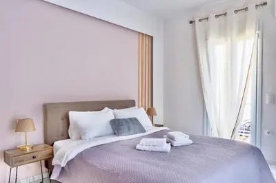 a bedroom with a large bed with two towels on it at Stylish Apartment in Athens, Walk Everywhere in Athens