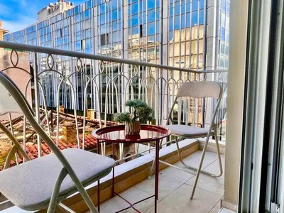 a balcony with two chairs and a table and a window at Stylish Apartment in Athens, Walk Everywhere in Athens