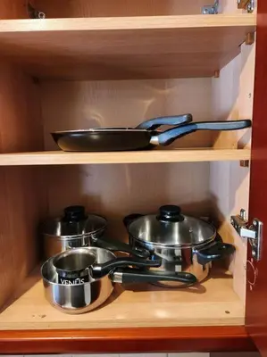 two pots and pans sitting on a wooden shelf at Comfy Place In Panteleymon VIPGreece in Athens