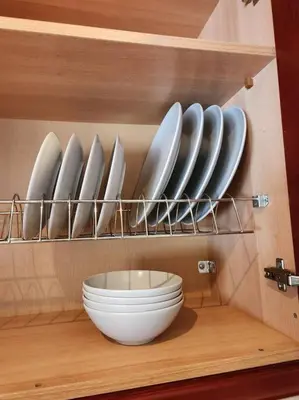 a shelf with plates and a bowl in a kitchen at Comfy Place In Panteleymon VIPGreece in Athens