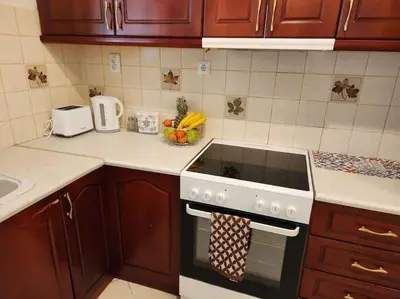 a kitchen with wooden cabinets and a stove top oven at Comfy Place In Panteleymon VIPGreece in Athens