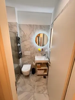 a bathroom with a toilet and a sink and a mirror at Casa de Tres Hermanos in the heart of Athens in Athens