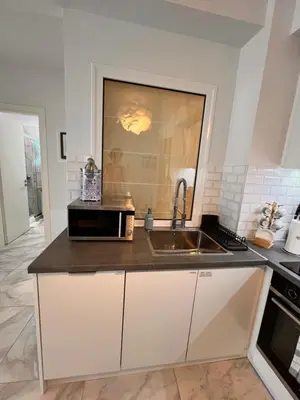 a kitchen with a sink and a microwave at Casa de Tres Hermanos in the heart of Athens in Athens
