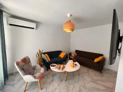 a living room with a couch and a table at Casa de Tres Hermanos in the heart of Athens in Athens