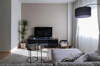 a living room with a couch and a tv at Acropolis Deluxe 2BR Apartment in Athens